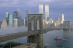 View of New York Skyline Brooklyn Bridge over the East River and Tugboat in Fog
